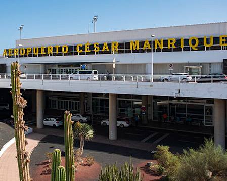 Lanzarote Airport César Manrique — terminal exterior with white Canarian architecture and blue sky