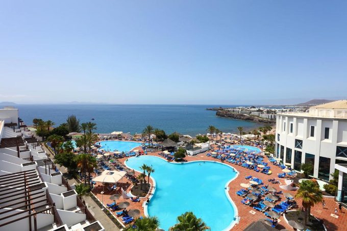 Sandos Papagayo Beach Resort pool and palm trees — all-inclusive family resort Playa Blanca Lanzarote